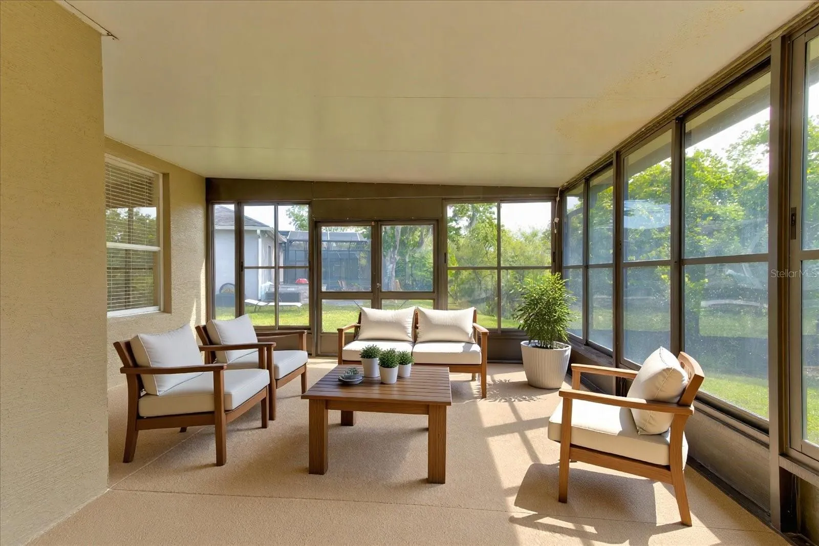 Outdoor living space sheltered with sliding windows
