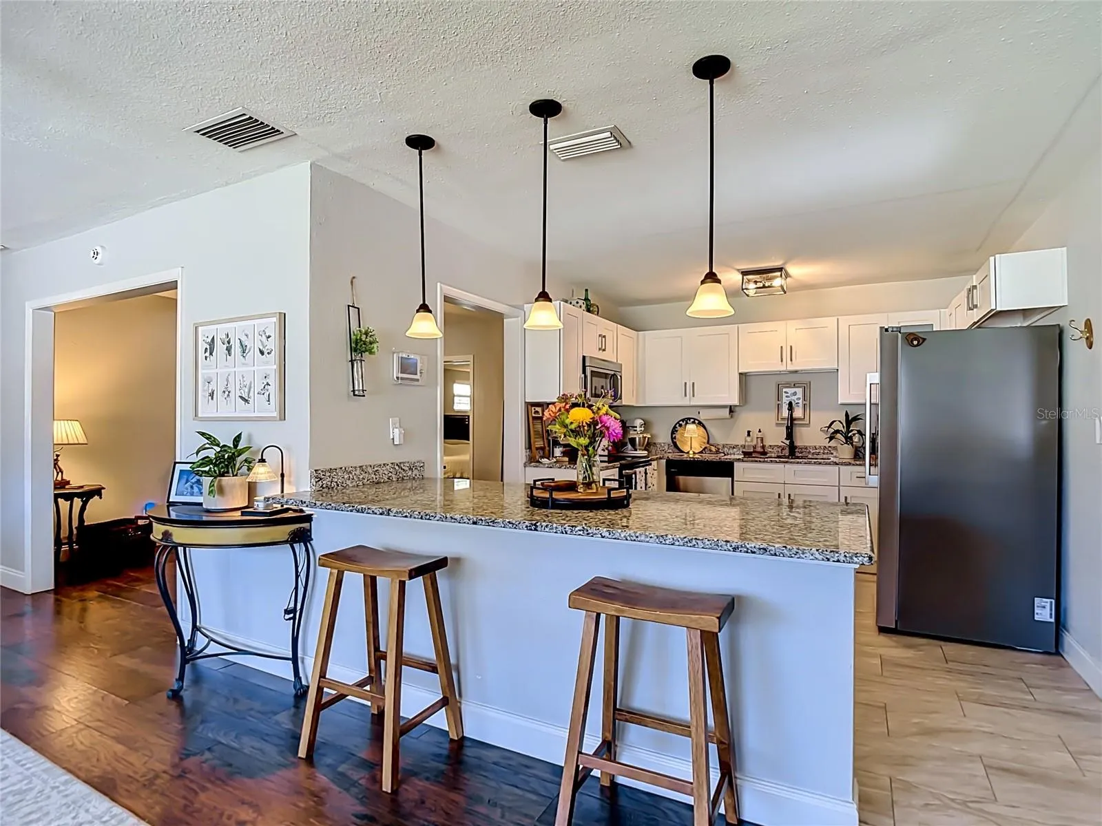 Sit at the Kitchen Bar while watching the cook