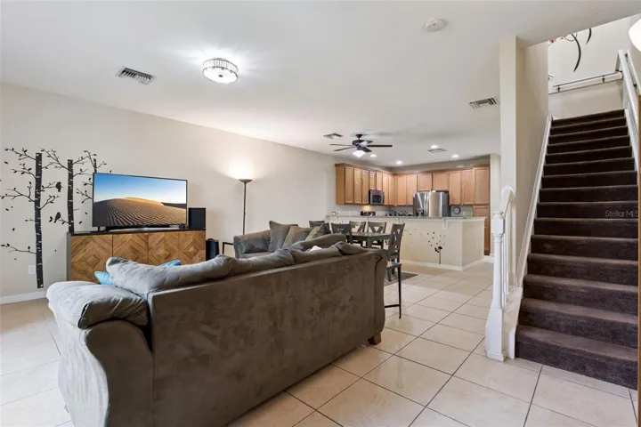 Staircase leading upstairs to 3 bedrooms and 2 bathrooms has storage underneath