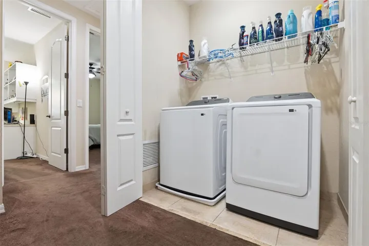 Upstairs laundry closet with newer washer and dryer included