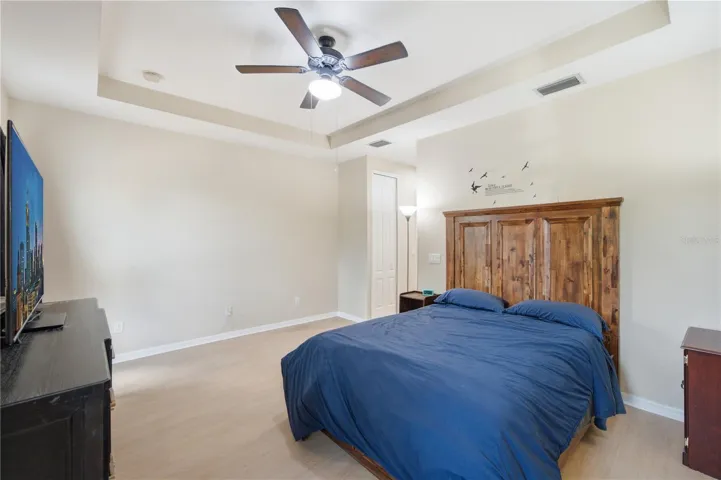 Primary bedroom with tray ceiling and two closets