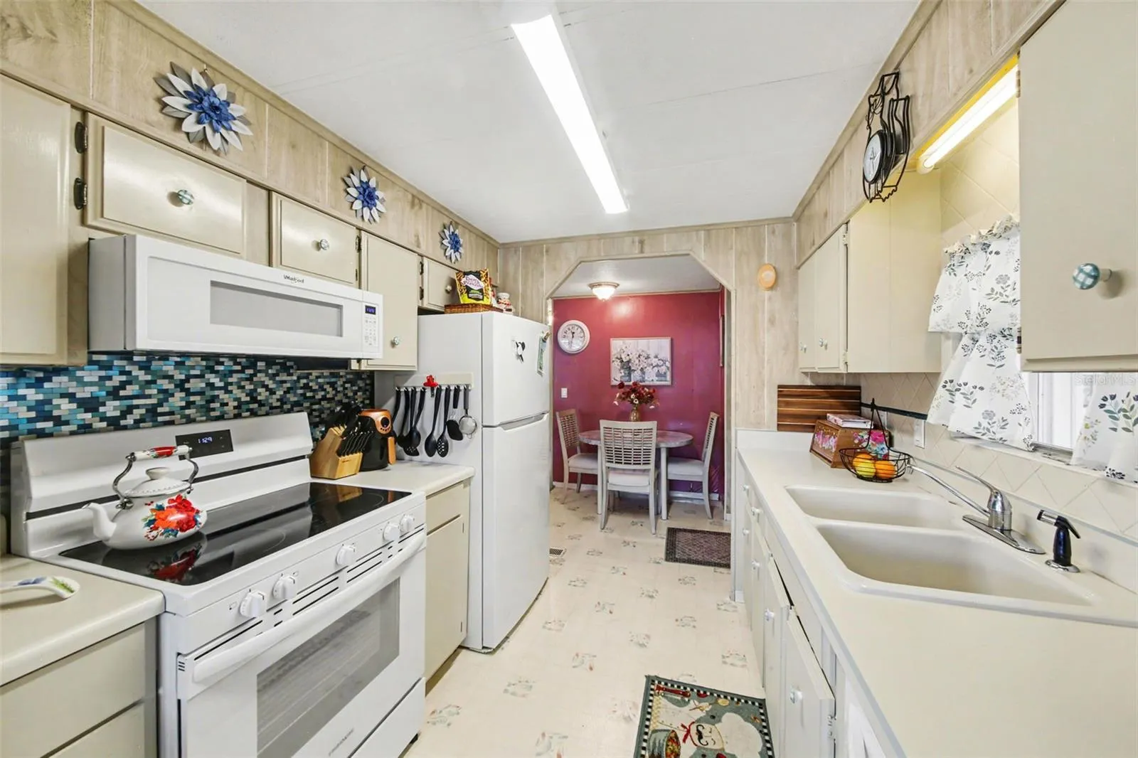 Galley kitchen with natural light coming in from the window.
