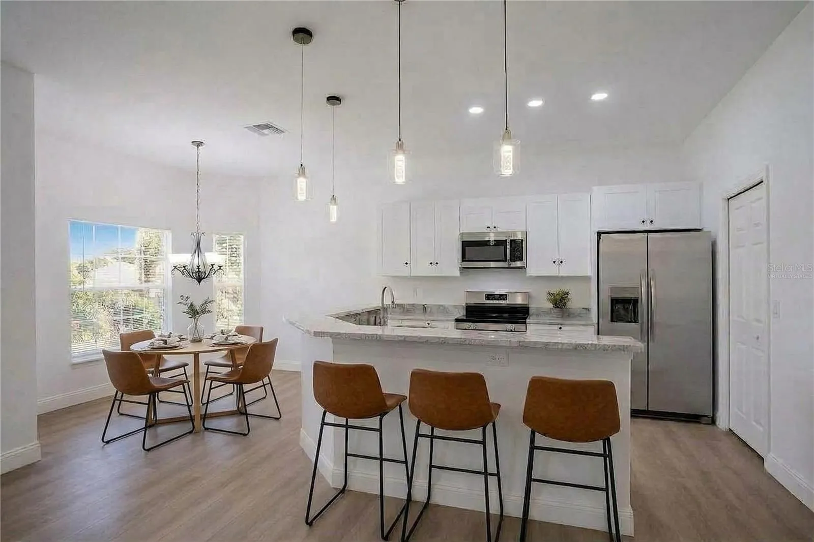 White Shaker Style Cabinetry with soft close hinges and matte black hardware, virtually staged