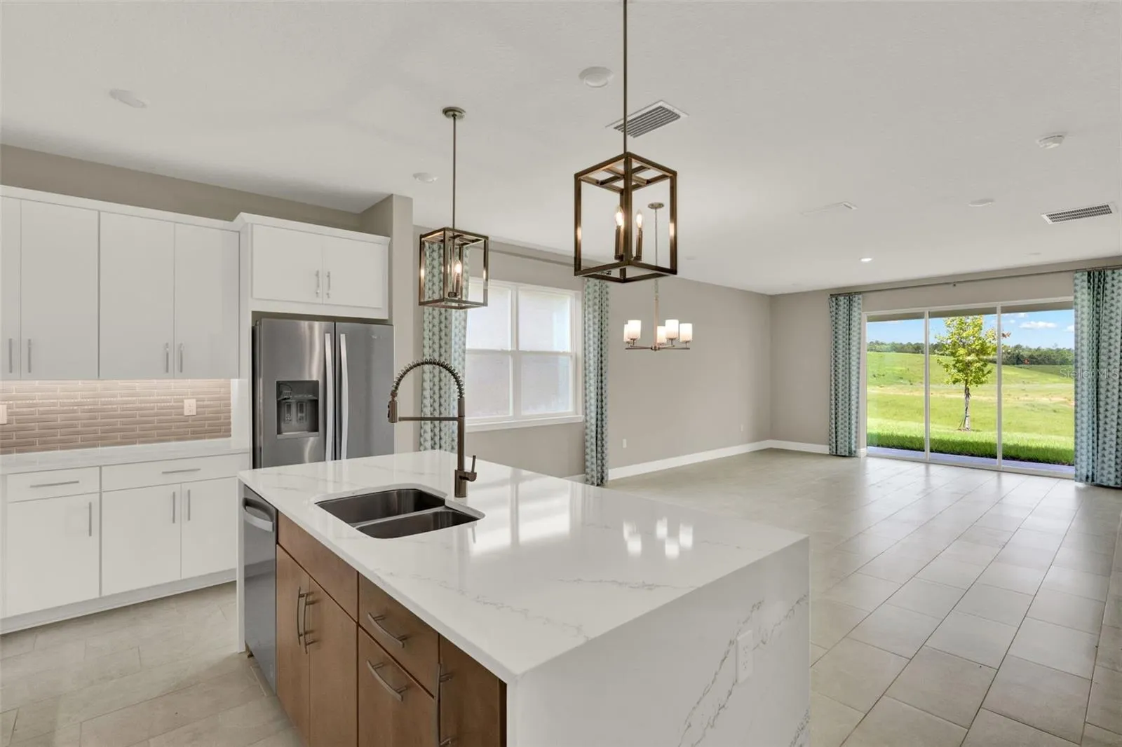 The quartz island and top tier cabinets create a luxurious kitchen!