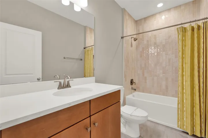 That tile... all the way to ceiling and top tier cabinetry in bathroom
