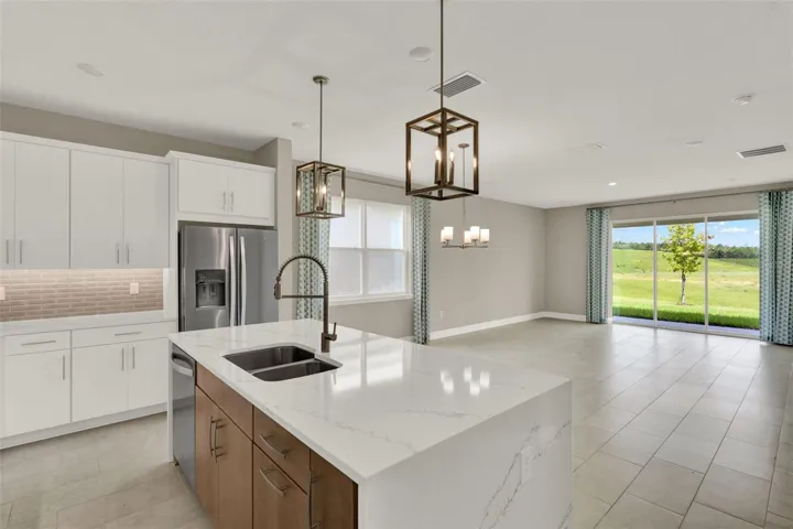 The quartz island and top tier cabinets create a luxurious kitchen!
