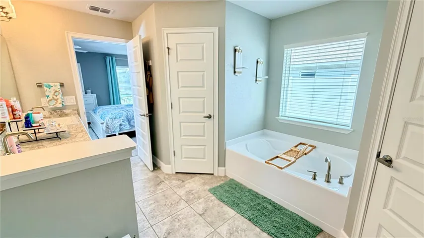 Primary bathroom, door access to one walk-in closet