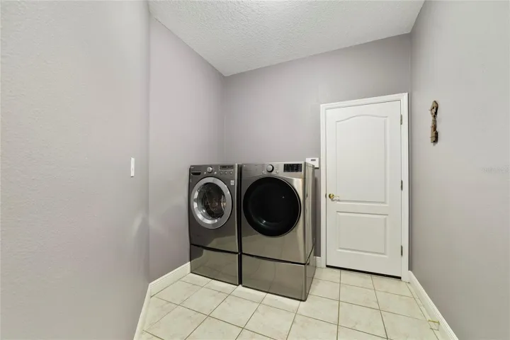 Spacious laundry room and garage access.
