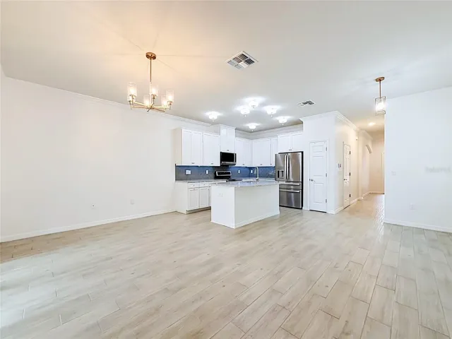 Open concept layout w/ high ceilings & crown moulding