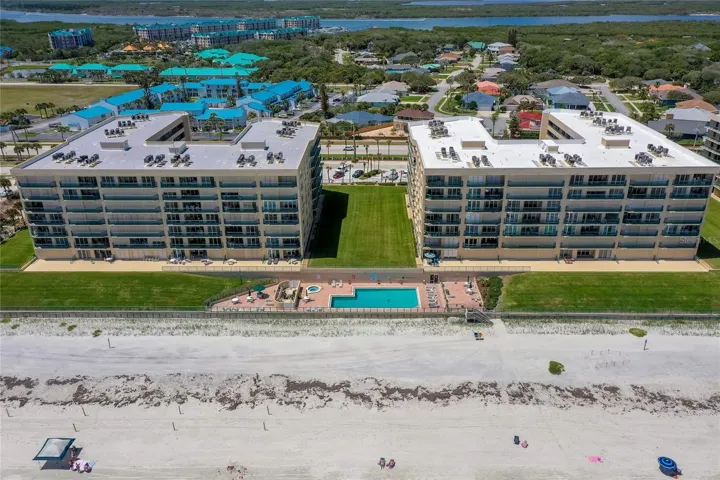 Resort-style pool and spa area situated just steps from the sand, offering a relaxing setting with ocean views.