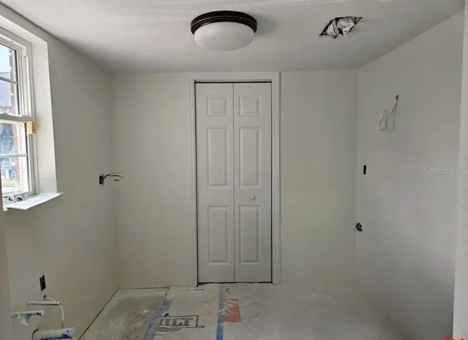 Kitchen with laundry closet for stackable washer/dryer & water heater