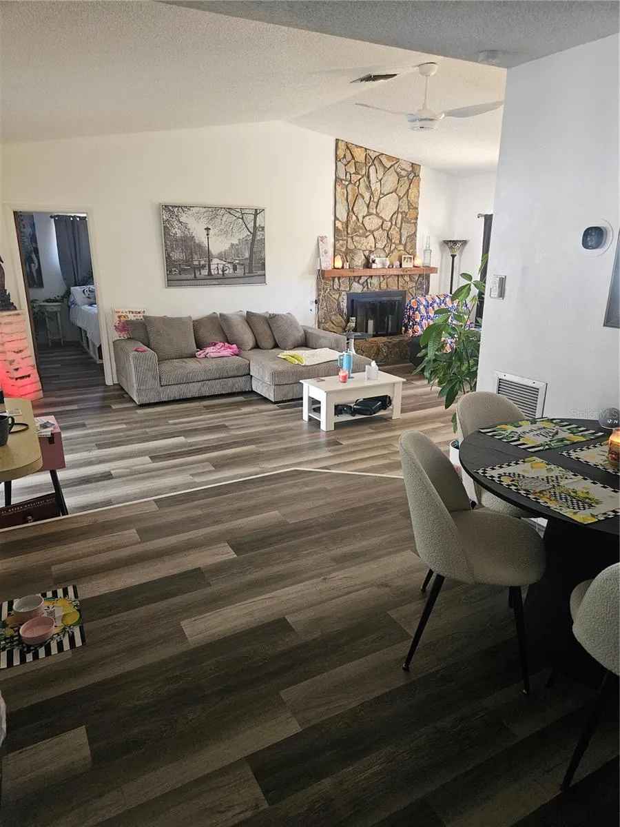 View from Dining Room to Living Room with Wood Burning Fireplace