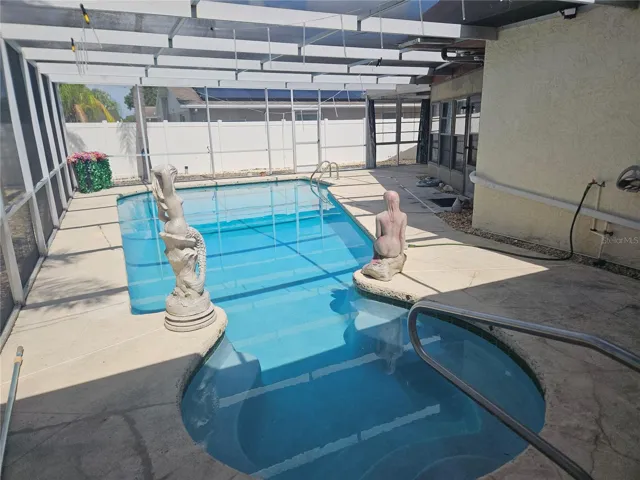 Pool with 2 covered living spaces under roofline