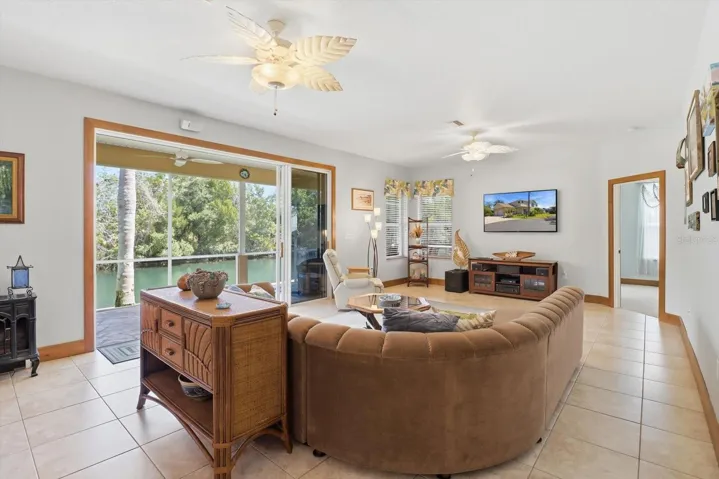 Great Room w/ Wiring for Surround Sound & Stacking Slider that Opens to a Covered Lanai...All Overlooking Spring Run Canal
