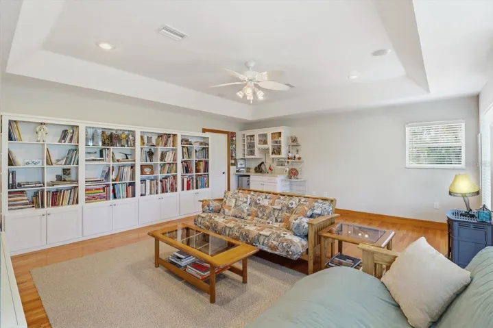 Family Room w/ Full Wall of Built Ins & Wet Bar w/ Mini Frig.. Door in Back Corner is Laundry Room
