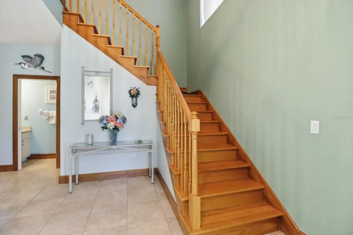 Solid Oak Staircase to the Second Floor w/ Hidden Storage Underneath...Half Bath on Left