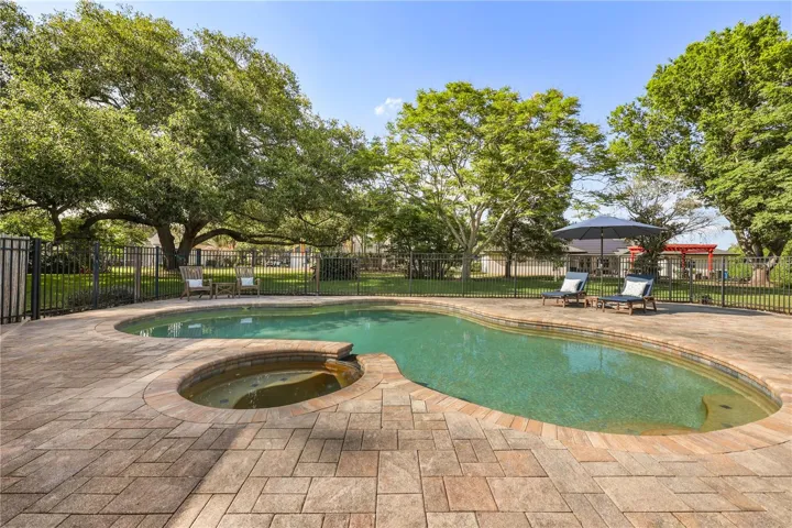 VIEW OF MATRURE TREES AND YARD FROM THE POOL