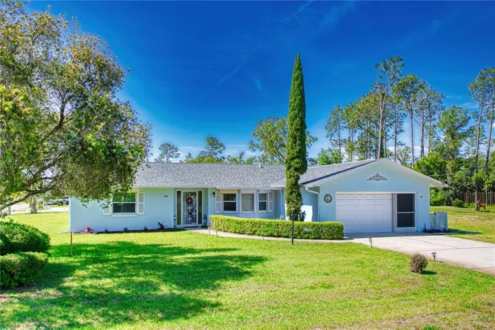 Set on an oversized corner lot, this inviting Palm Coast pool home makes a wonderful first impression with its manicured lawn, mature landscaping, welcoming front entry, and clean, well-kept exterior. The wide frontage, fenced side yard, screened garage, and attractive setting give the home a bright, comfortable feel before you even step inside.