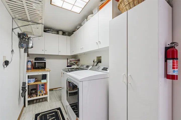 Spacious laundry area with cabinet space