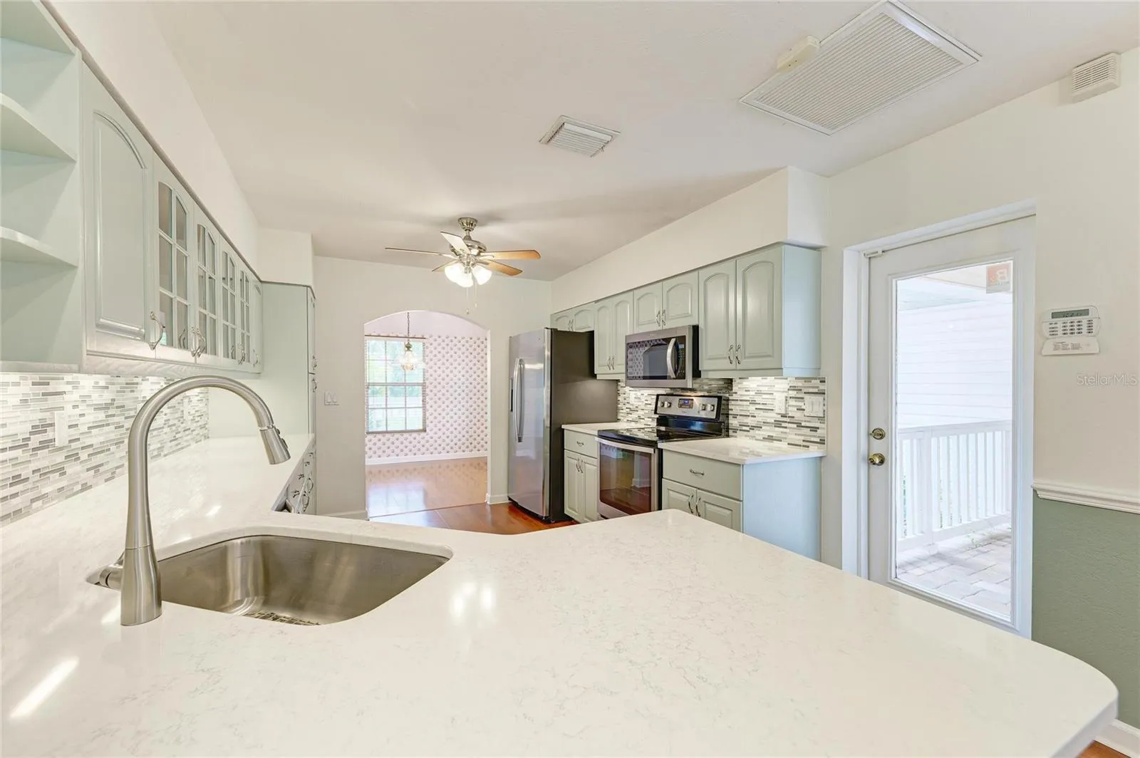 Remodeled kitchen facing front of home and dining room