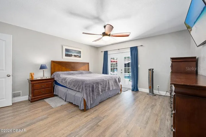 Primary Bedroom with Sliders to the Pool