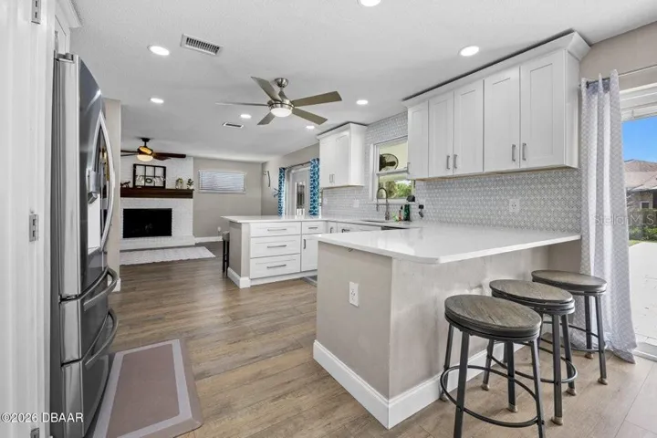 Kitchen with Crown Molding and Family Room Beyond