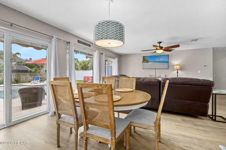 Dining Area with Sliders to the Left and Living Room Beyond