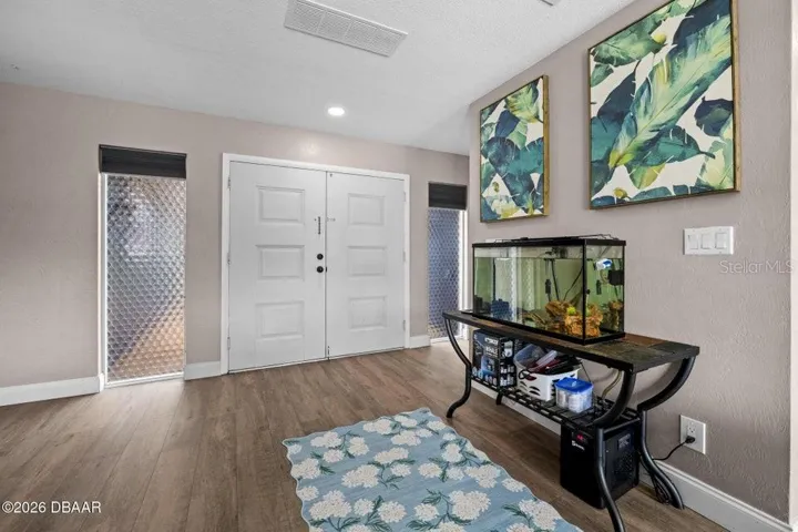 10 Foyer Entrance with Hallway to the Right of Garage, Laundry & Half Bath