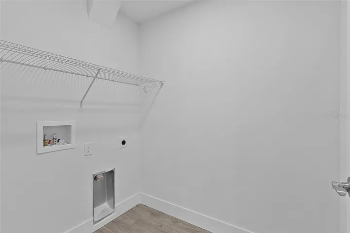 Indoor laundry with washer and electric dryer hookups