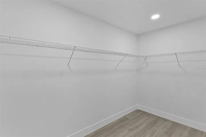 Primary bedroom walk-in closet