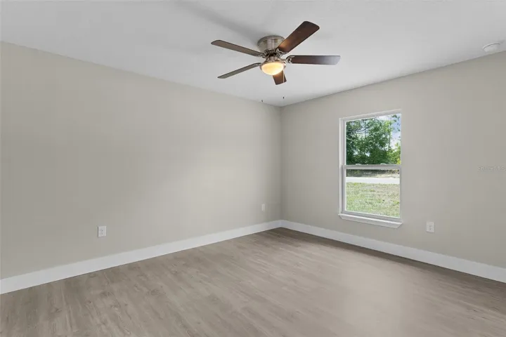 Bedroom 3 on the back of the house with window facing side yard
