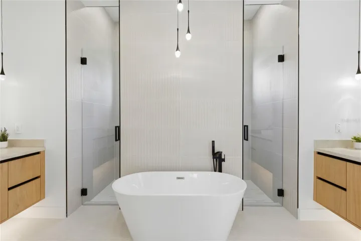LUXURIOUS MASTER BATH w/ DOUBLE RAINFALL SHOWERS & handheld showerheads, STANDALONE TUB & custom vanities w/ VESSEL SINKS, indulgent SPA ATMOSPHERE