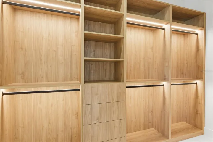 HIS-&-HER walk-in CLOSETS w/ FULL WALL custom LIGHTED CABINETRY