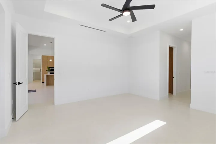 Spacious primary bedroom featuring sliding glass doors that open privately to the lanai for seamless indoor-outdoor living