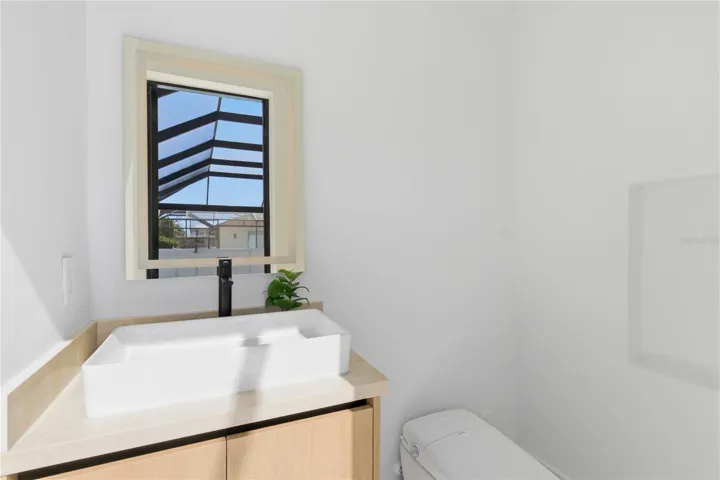 Convenient cabana pool half bathroom with direct outdoor access, ideal for seamless indoor-outdoor living and effortless entertaining!