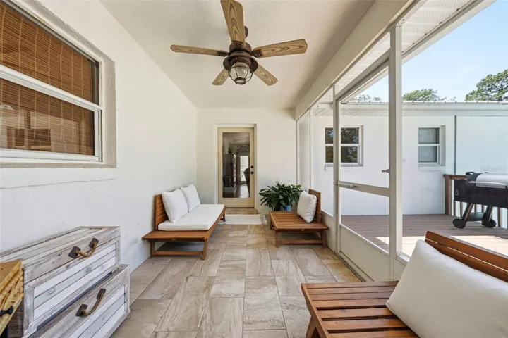 screened back porch with door to the family room