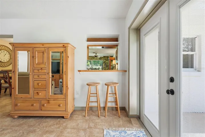 Family room showing the pass-through to the kitchen and French doors to the side patio