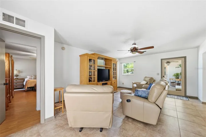 family room with Master bedroom entry on the left and glass door to the screened porch