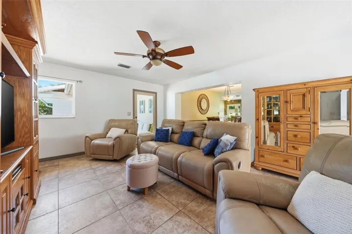 Family room showing door to the screened porch and kitchen dining beyond