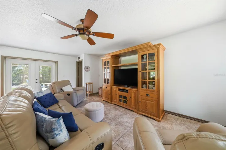 Family room showing French doors to the side patio and Master Bedroom door.