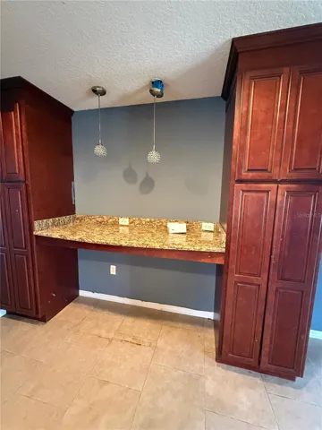 extra kitchen storage with upgraded  cabinets and granite counters