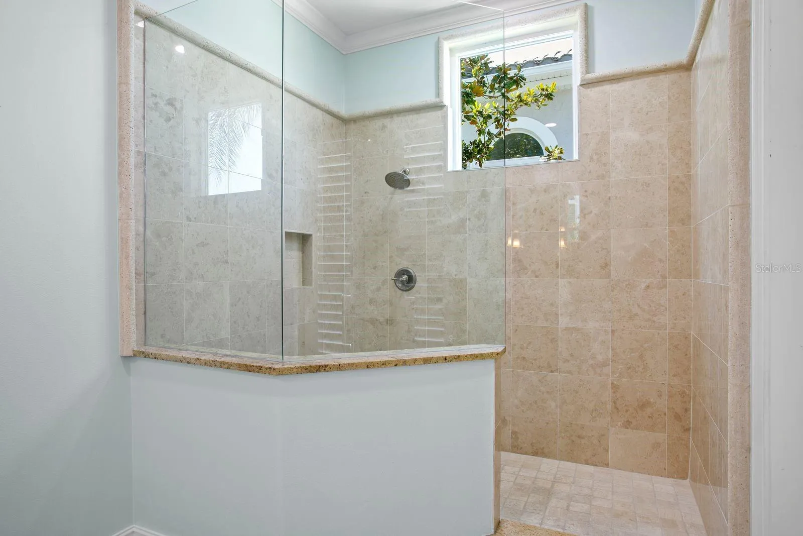 View of the walk-in shower in the main level primary ensuite.