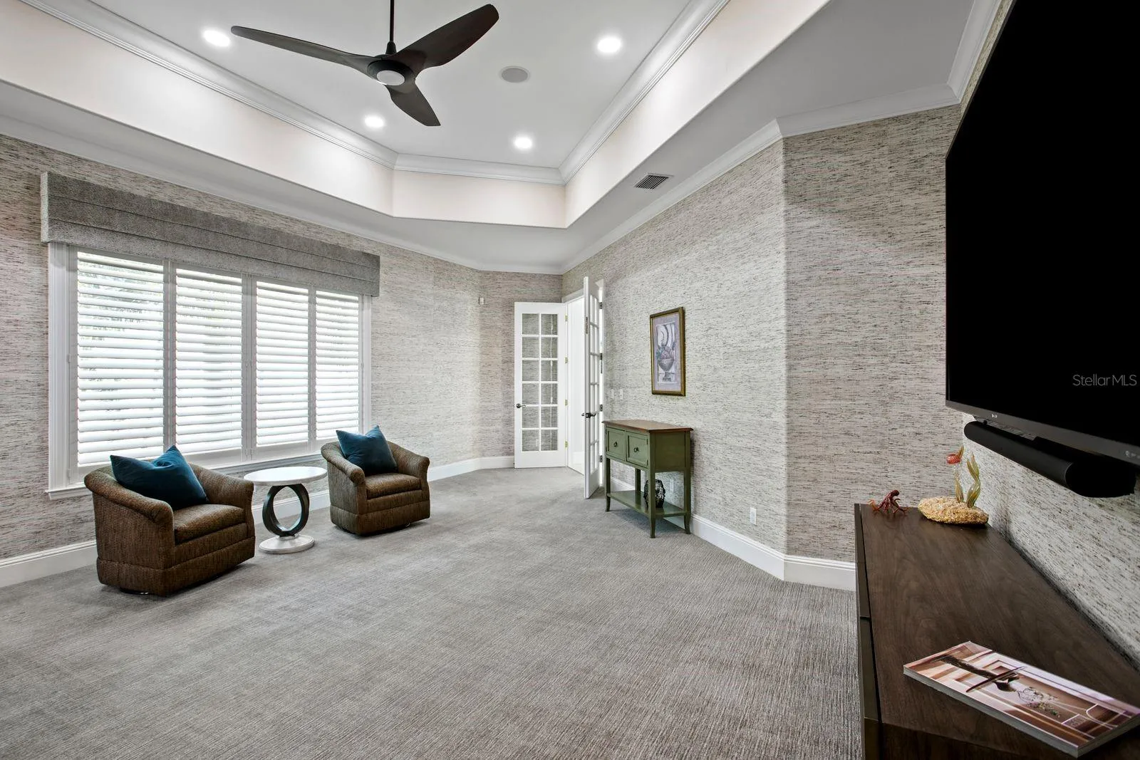 A sophisticated social lounge complete with a built in bar and media area.