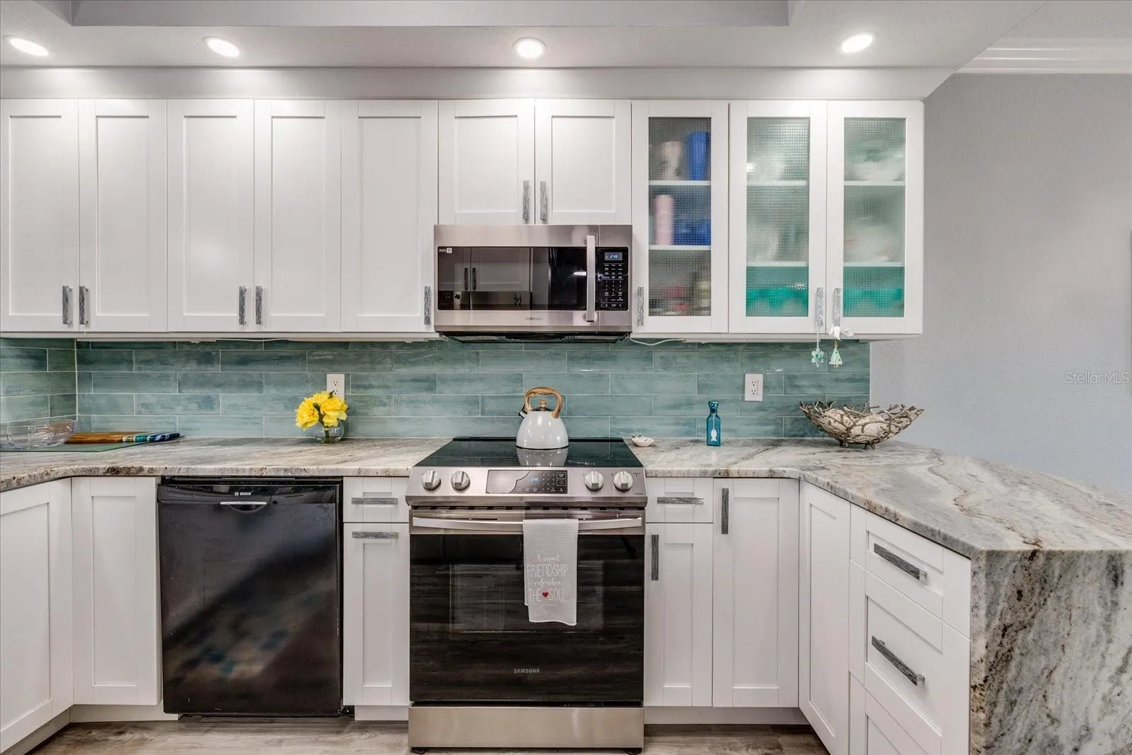Updated gourmet kitchen with granite featuring waterfall edge