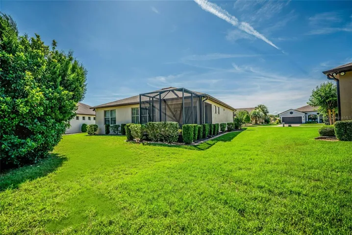 The back of the home has lush landscaping for a privite setting.