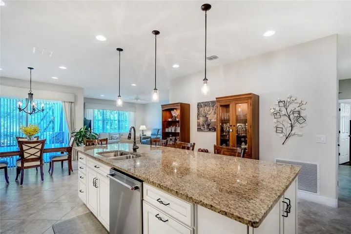 Large granite kitchen counter with plenty of room for stools.