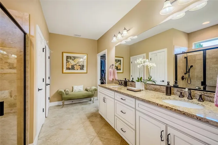 Primary bathroom with duel sinks, solid counter top.