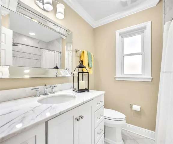 Renovated 2nd bath includes oversized vanity with marble counters