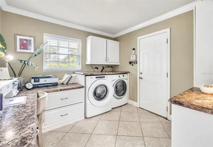 Laundry Room/ with lot of storage cabinetry & access to 2 car garage