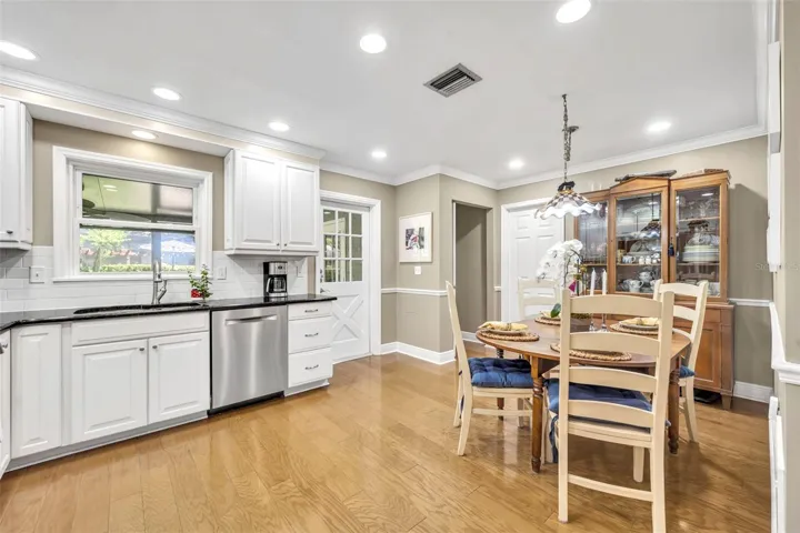 Kitchen window overlooking screened in patio and backyard